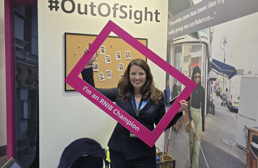 Joy holding RNIB sign