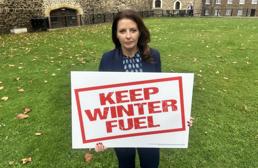 Joy holding Keep Winter Fuel sign