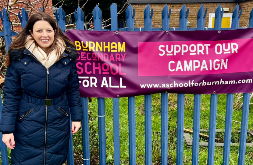 JM in front of Burnham School sign