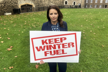 Joy holding Keep Winter Fuel sign