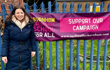 JM in front of Burnham School sign